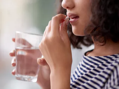 Woman taking pill
