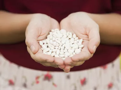 Woman holding white beans