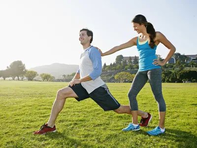 Couple stretching in the park