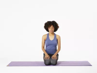 Woman on yoga mat showing ocean breath