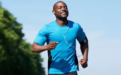 Portrait of an active African American man running exercise workout outdoors