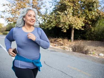 Mature Mexican woman jogging on a traile