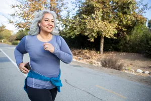 Mature Mexican woman jogging on a traile