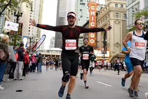 CHICAGO, ILLINOIS - OCTOBER 13: A general view of competitors runing past the Chicago Theater during the 2019 Bank of America Chicago Marathon on October 13, 2019 in Chicago, Illinois. (Photo by Quinn Harris/Getty Images)