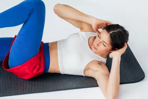 Beautiful woman exercising in studio on white background