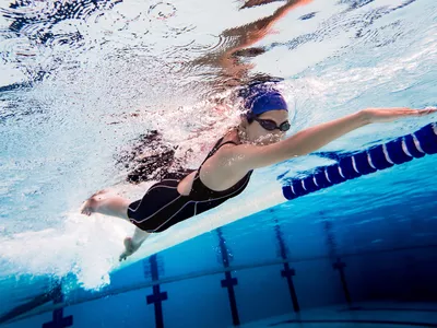 Woman swimming pool.Underwater photo