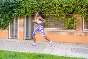 A Sports Black Woman With Braids Doing Daily Running Exercise Workout On The Streets Near Home.