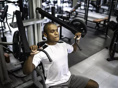 Man doing strength workout exercise in gym