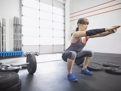 Woman doing squats in gym