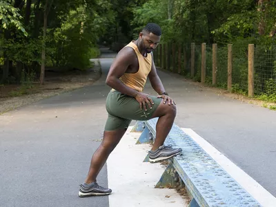 man stretching on a bench