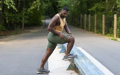 man stretching on a bench