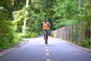 man sprinting down the middle of a trail