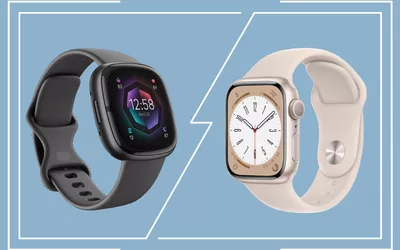 A Fitbit and Apple Watch atop a decorative blue background