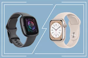 A Fitbit and Apple Watch atop a decorative blue background