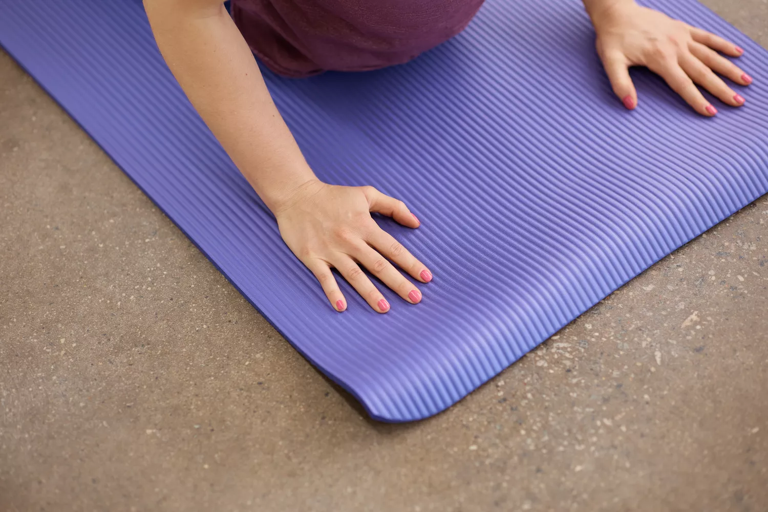 Person pressing hands on BalanceFrom GoYoga All-Purpose Yoga Mat while performing yoga