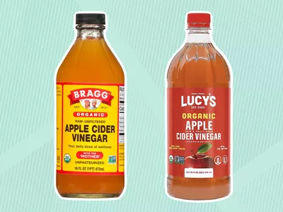 Bragg Organic Apple Cider Vinegar and Lucy's Organic Apple Cider Vinegar displayed on a blue patterned background
