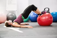 Person exercising using GoFit Pro Grade Stability Ball on gym mats