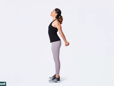 woman doing standing chest opener stretch