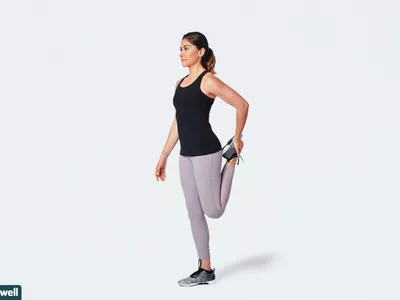 woman doing standing quad stretch