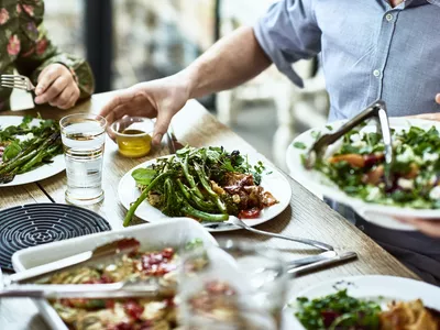 Cropped view of table laid with fresh homemade vegetarian food.