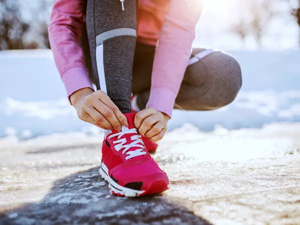 Woman lacing up her sneakers