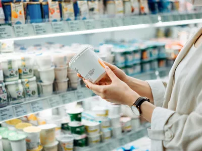Woman reading a food label at the grocery store