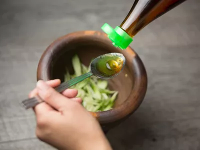 pouring fish sauce into a spoon