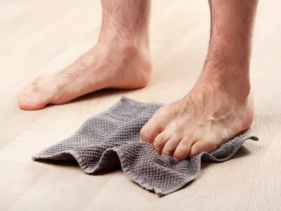 person doing to curl with towel