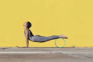 woman using yoga wheel