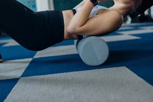 woman foam rolling her back muscles
