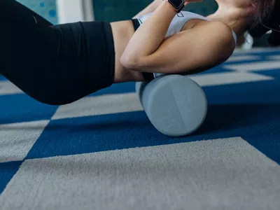 woman foam rolling her back muscles