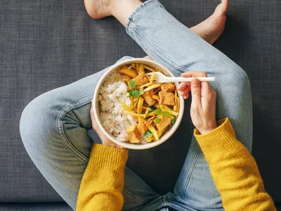 Woman eating rice with tofu for lunch