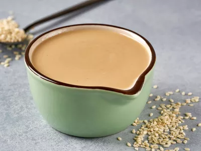 dish of tahini next to sesame seeds