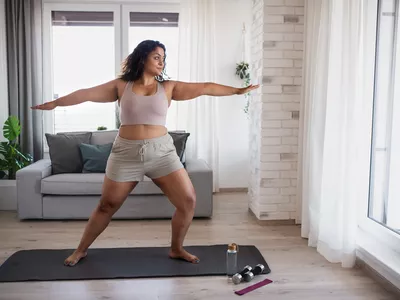 woman performing yoga in living room