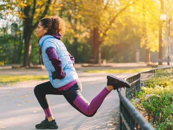 woman doing a Bulgarian split squat outside