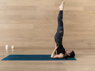 woman doing a shoulder stand