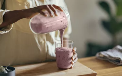 Anonymous Afro-American Woman Pouring a Smoothie into a Glass