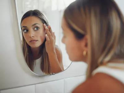 Woman looking in mirror