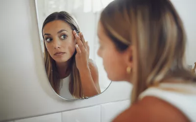 Woman looking in mirror