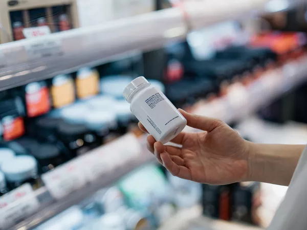 Person shopping for vitamins