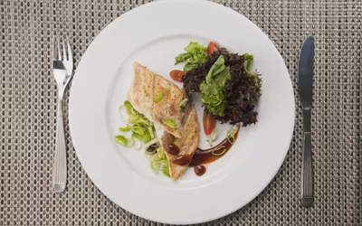 overhead shot of plate of salmon with salad