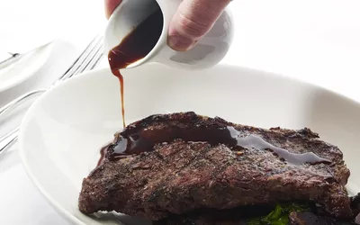 worcestershire sauce poured on steak