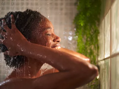 Young Black woman showering