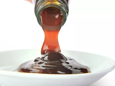 Pouring oyster sauce from a bottle