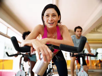 woman resting on exercise bike