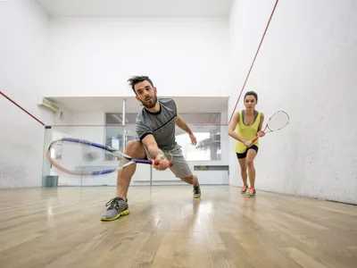 Below view of young man and woman playing squash