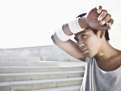 A man sweating while exercising outside