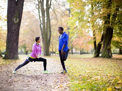 Couple stretching outside