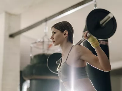 Female weight lifting with barbell