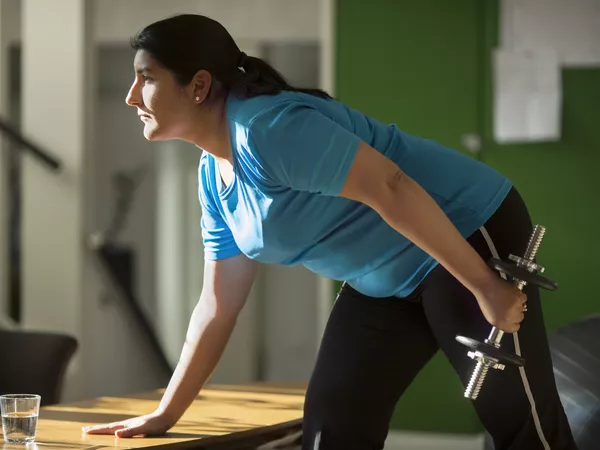 Woman lifting weights at home